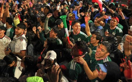 Fan celebrates Mexico advancing in the World Cup by dunking his head into a cotton candy machine