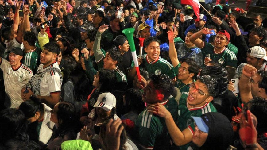 Fan celebrates Mexico advancing in the World Cup by dunking his head into a cotton candy machine