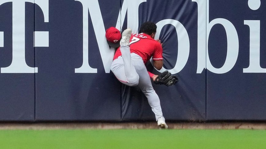 Reds' Dane Myers carted off field after crashing into wall making acrobatic catch vs Brewers