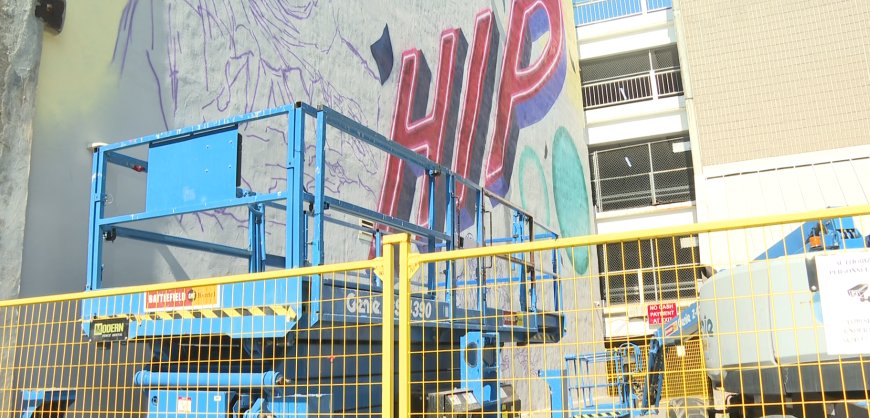 Three-storey Tragically Hip mural being painted in downtown Kingston