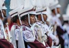 Marching band tuba player unleashes punches on man at college football game without missing a beat