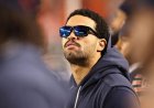 Caleb Williams, limited by a hamstring injury, seen casually pacing Bears sideline during national anthem