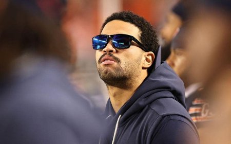 Caleb Williams, limited by a hamstring injury, seen casually pacing Bears sideline during national anthem